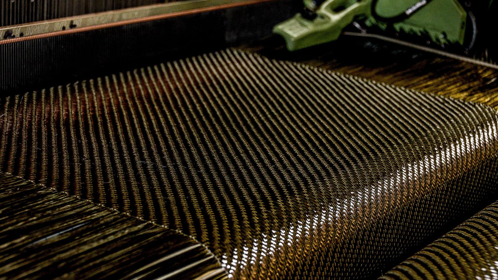Carbon fibre fabric being woven on a loom