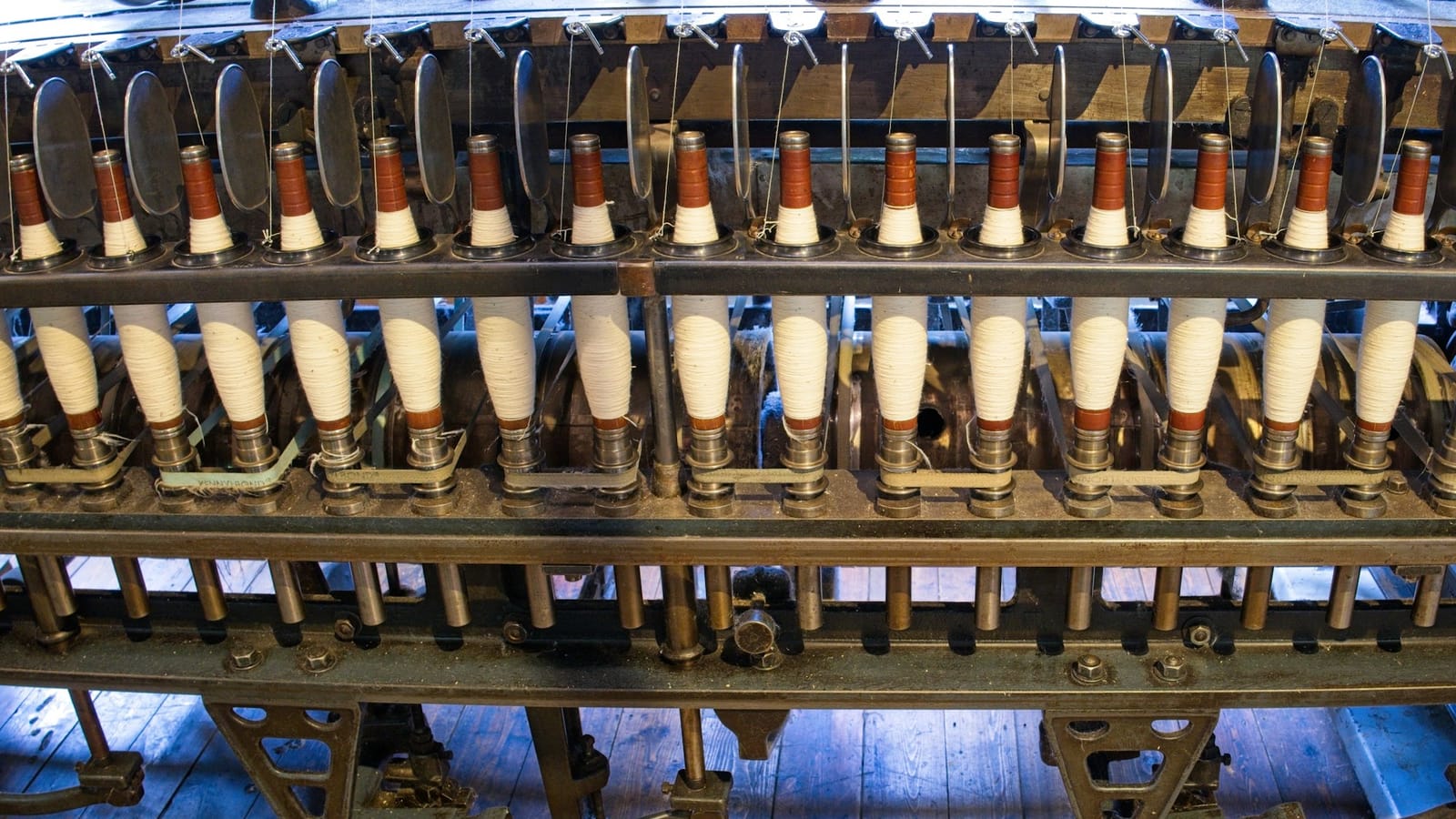 Rows of bobbins on a spinning machine