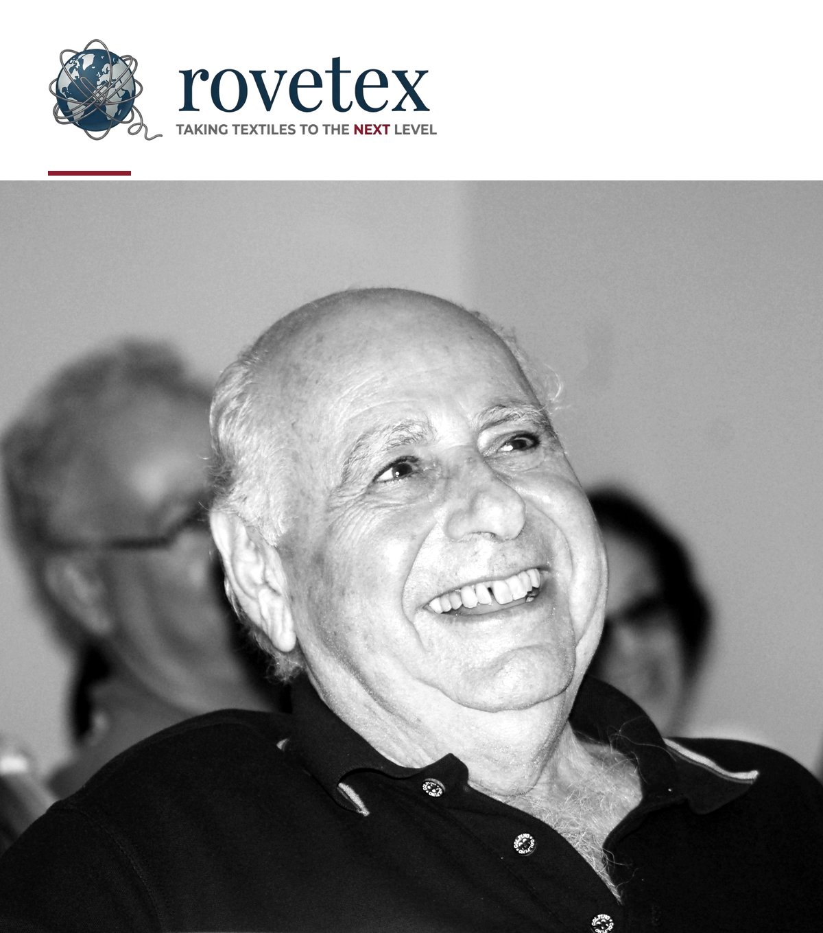 Black-and-white photograph of Sacha Hagin smiling, with the Rovetex logo above